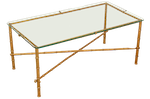 A glass cocktail table with faux bamboo in gold,